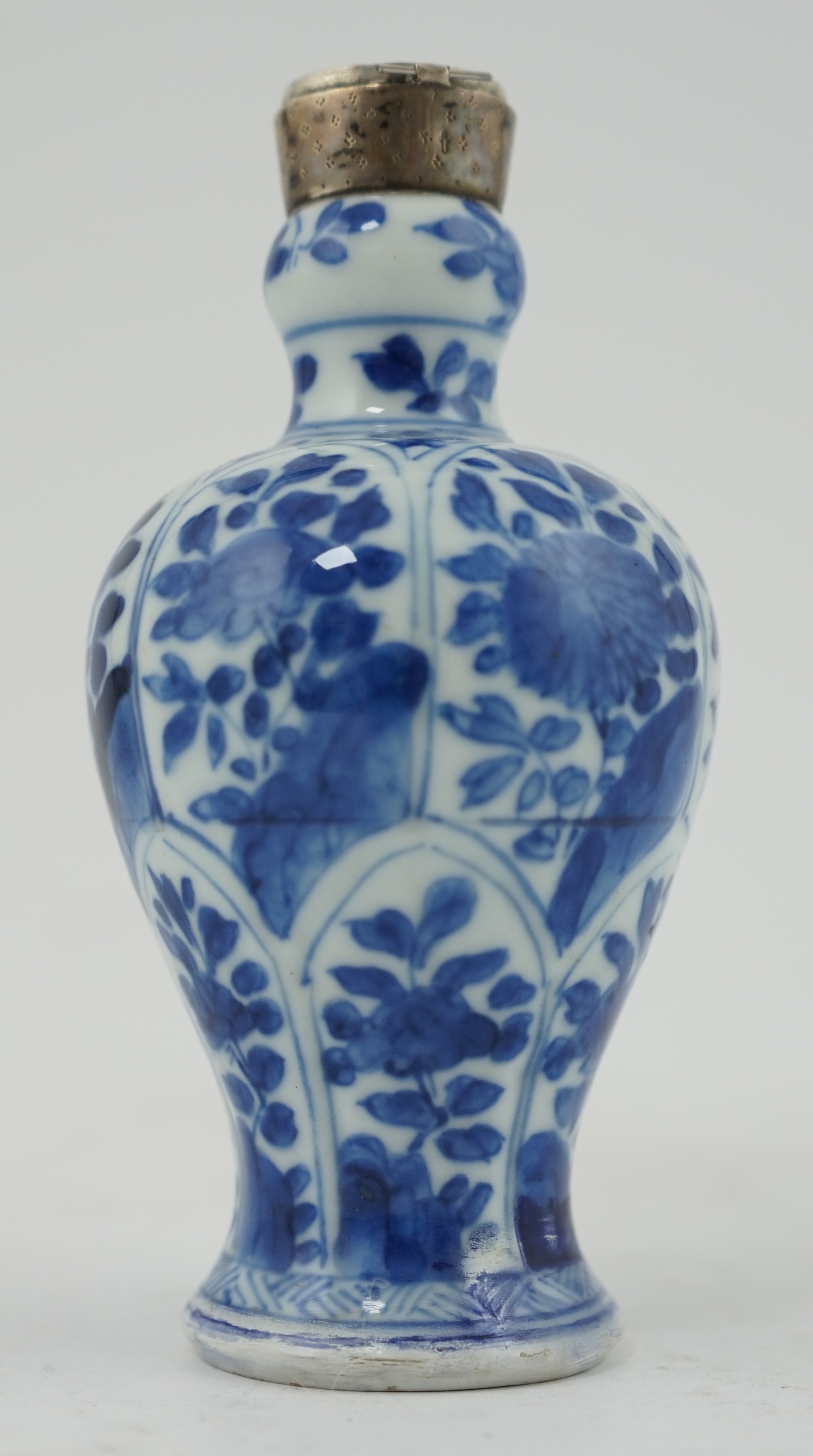 A Chinese small blue and white, white metal mounted vase, Kangxi, 12cm. Condition - poor to fair